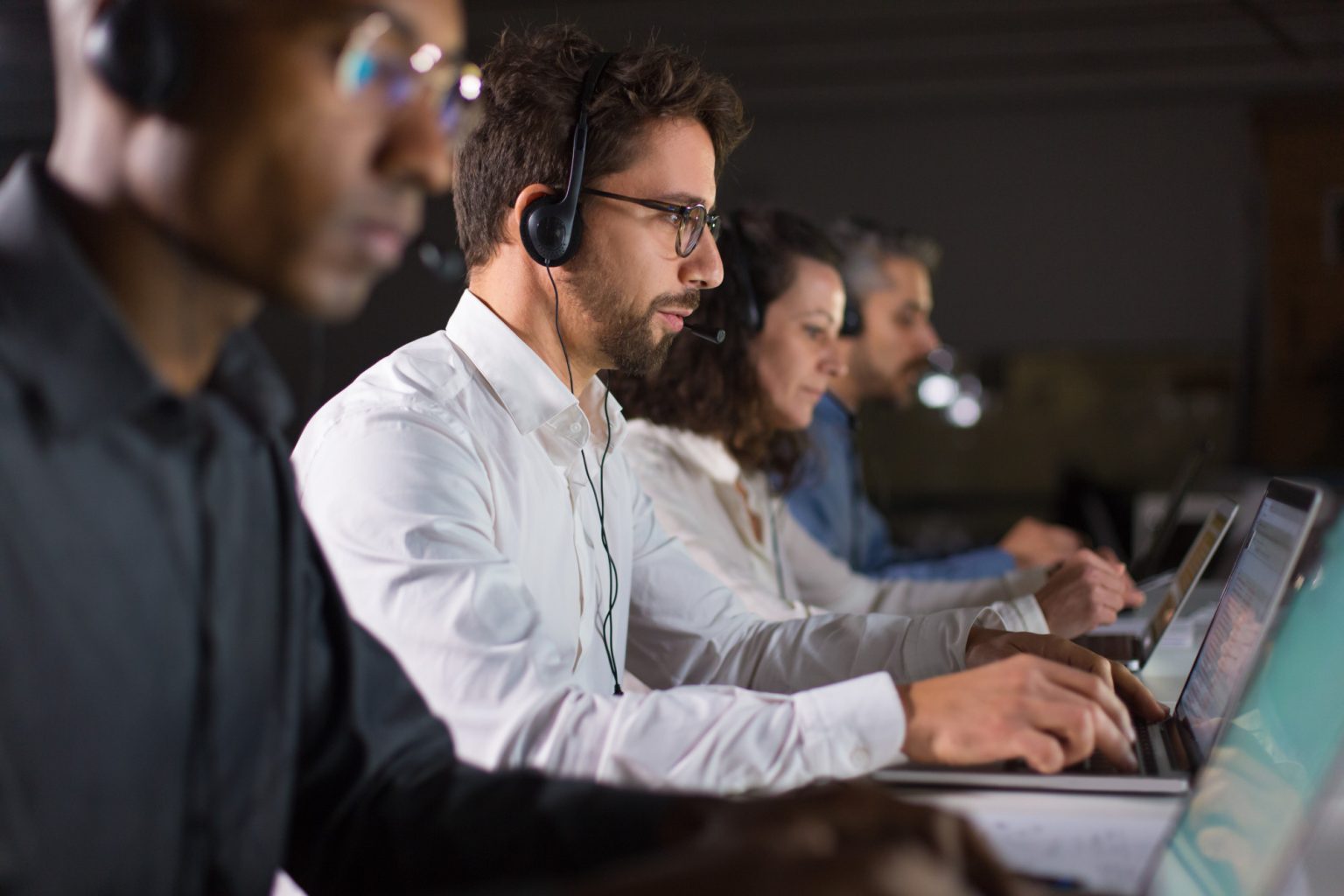 Staffing Services confident call center operator talking with client 1536x1024